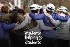 Little 500 riders with their arms over each others shoulders.